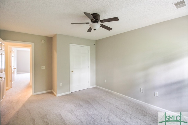 unfurnished bedroom with a textured ceiling, carpet flooring, and ceiling fan