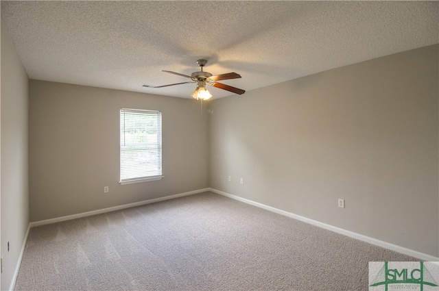 spare room featuring carpet flooring, ceiling fan, and a textured ceiling