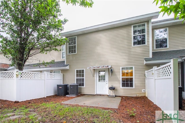 rear view of property with a patio area and central AC unit