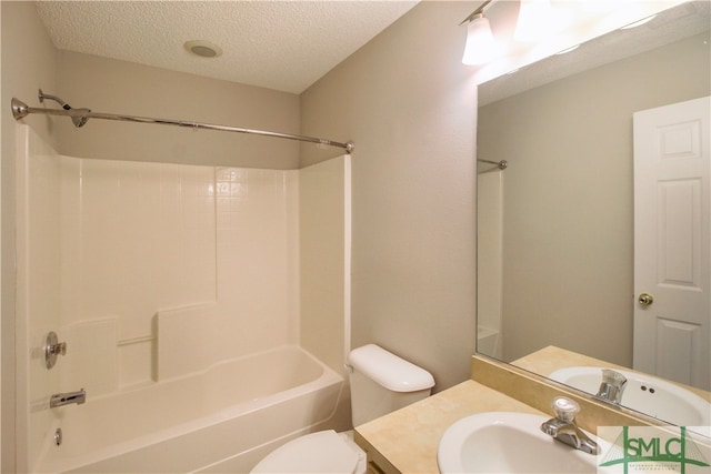 full bathroom with washtub / shower combination, vanity, toilet, and a textured ceiling