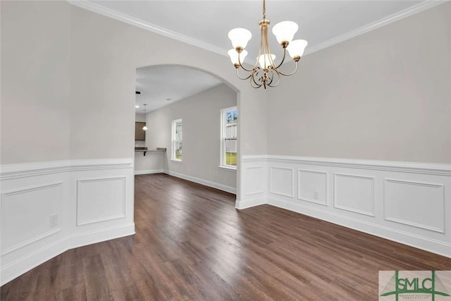 unfurnished dining area with dark hardwood / wood-style floors, a notable chandelier, and ornamental molding