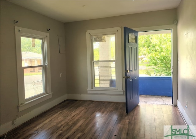 unfurnished room featuring a wealth of natural light and hardwood / wood-style flooring