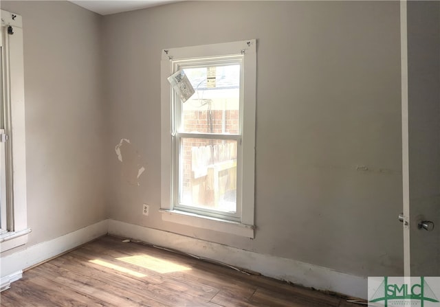 unfurnished room featuring hardwood / wood-style flooring