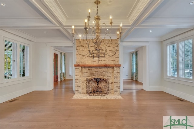 unfurnished living room with a fireplace, coffered ceiling, wood-type flooring, and a chandelier