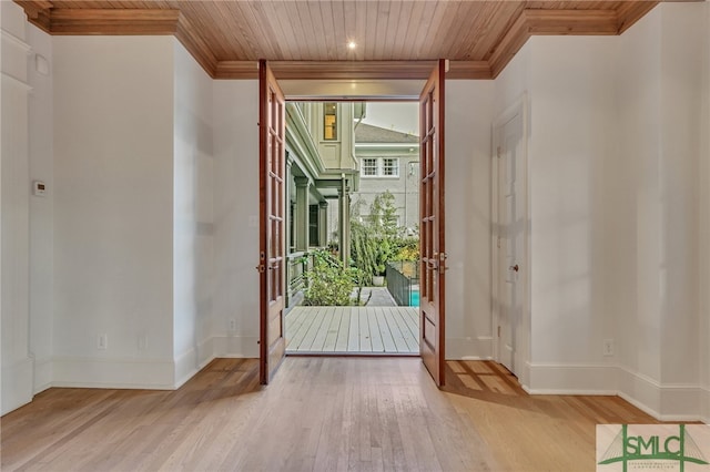 doorway to outside featuring light wood-type flooring, ornamental molding, and wooden ceiling