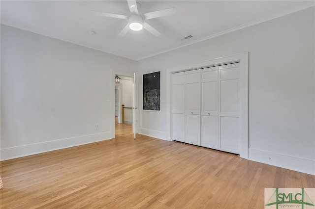 unfurnished bedroom featuring a closet, ceiling fan, ornamental molding, and light hardwood / wood-style flooring