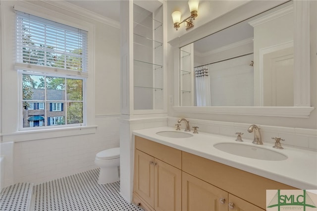 bathroom featuring toilet, crown molding, vanity, tile walls, and a shower with shower curtain