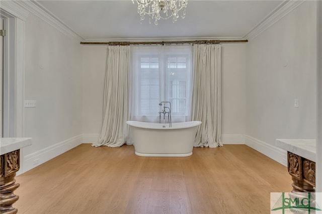 interior space featuring ornamental molding, a chandelier, and light hardwood / wood-style floors