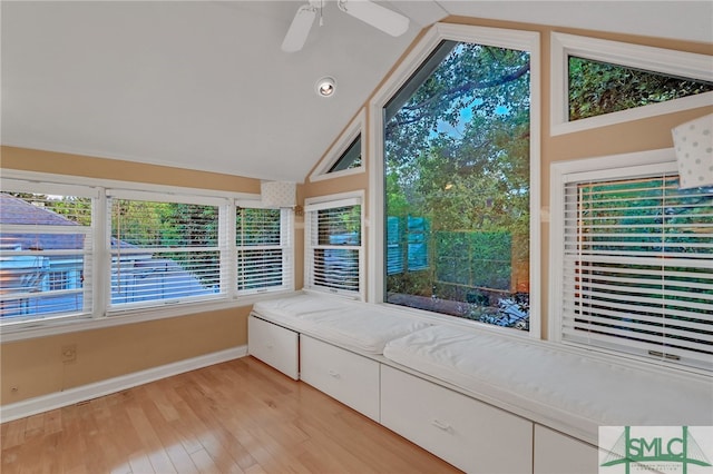 unfurnished sunroom featuring vaulted ceiling, plenty of natural light, and ceiling fan