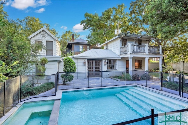 view of pool featuring an in ground hot tub