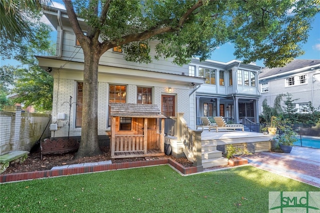 rear view of property with a yard