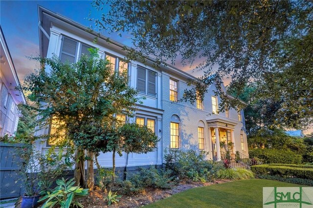 205 E 44th St, Savannah, GA 31405 - rear view of house with brick siding and a lawn