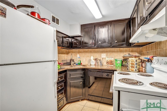 kitchen with white appliances, backsplash, dark brown cabinetry, sink, and light tile flooring