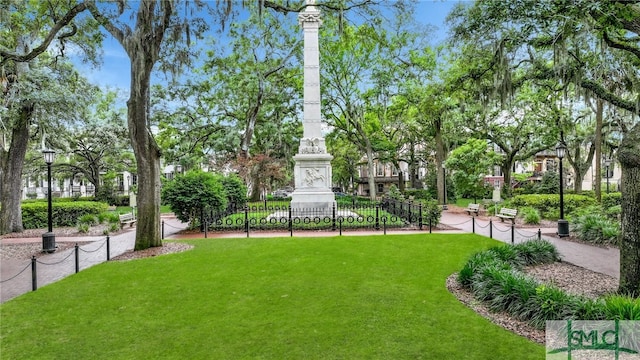 view of property's community with a lawn