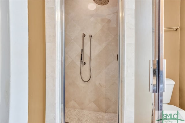 bathroom with an enclosed shower and toilet