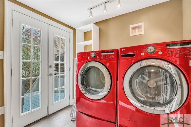 laundry area featuring french doors, washer and clothes dryer, track lighting, and light tile floors