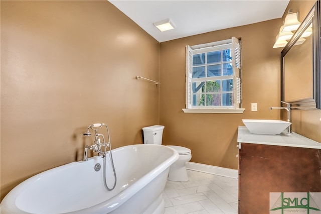 bathroom featuring tile floors, a bath to relax in, toilet, and vanity