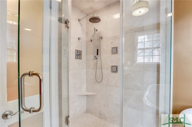 bathroom featuring a shower with shower door