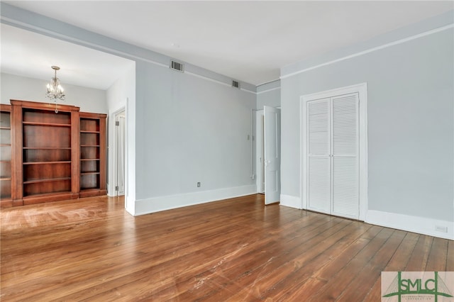 interior space with a notable chandelier and wood-type flooring