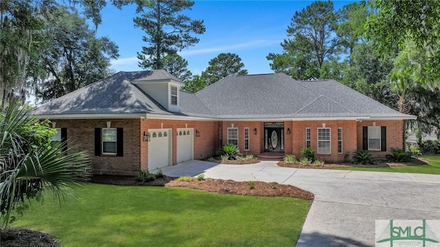 view of front of house featuring a garage and a front lawn