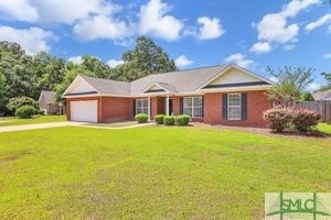 ranch-style home with a front yard and a garage