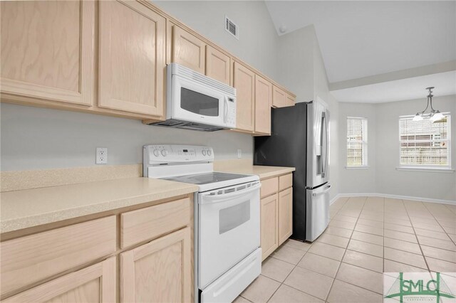 kitchen with vaulted ceiling, an inviting chandelier, white appliances, and light brown cabinetry