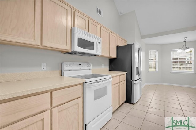 kitchen with white appliances, light brown cabinets, visible vents, light tile patterned flooring, and vaulted ceiling