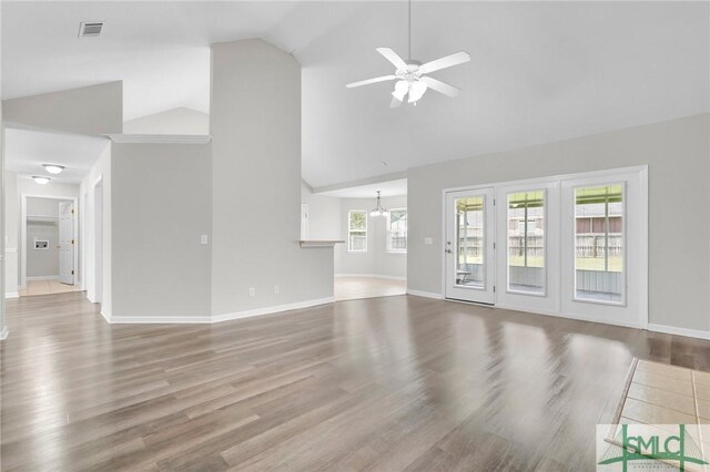 unfurnished living room with ceiling fan, hardwood / wood-style flooring, and high vaulted ceiling