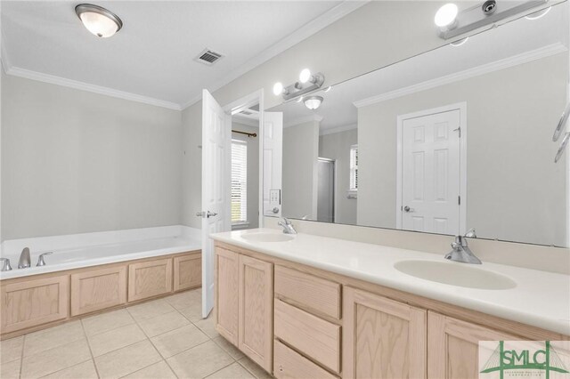 bathroom with ornamental molding, a bathtub, dual vanity, and tile patterned floors