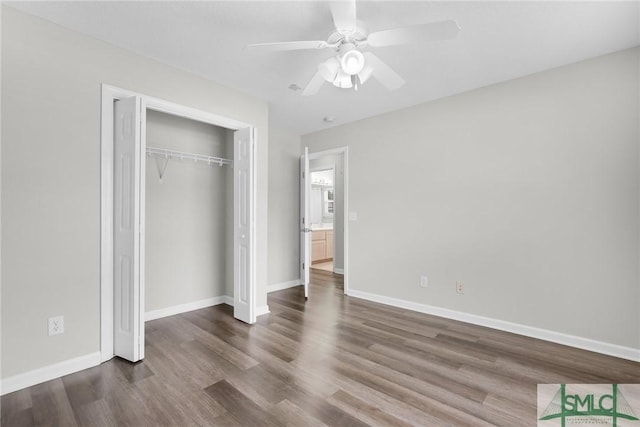 unfurnished bedroom featuring a closet, baseboards, wood finished floors, and a ceiling fan