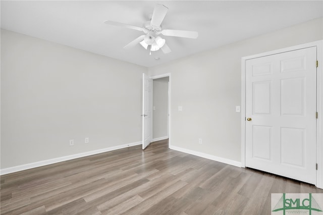 unfurnished bedroom with ceiling fan and hardwood / wood-style flooring