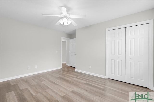 unfurnished bedroom featuring ceiling fan, light hardwood / wood-style flooring, and a closet