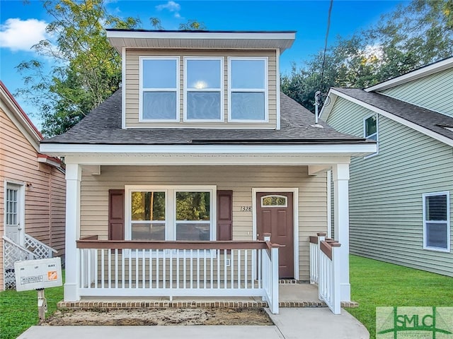 view of front of property featuring a front lawn and covered porch