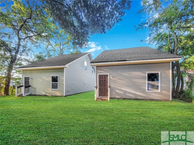 back of house featuring a yard