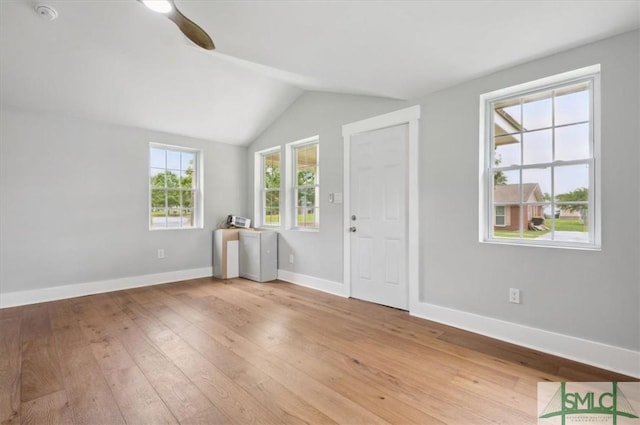 foyer entrance with ceiling fan, hardwood / wood-style floors, and vaulted ceiling