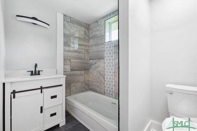 full bathroom featuring tile patterned floors, vanity, toilet, and tiled shower / bath