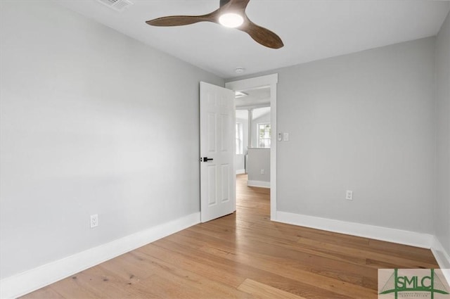 spare room with ceiling fan and light wood-type flooring