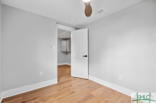 empty room featuring ceiling fan and light wood-type flooring