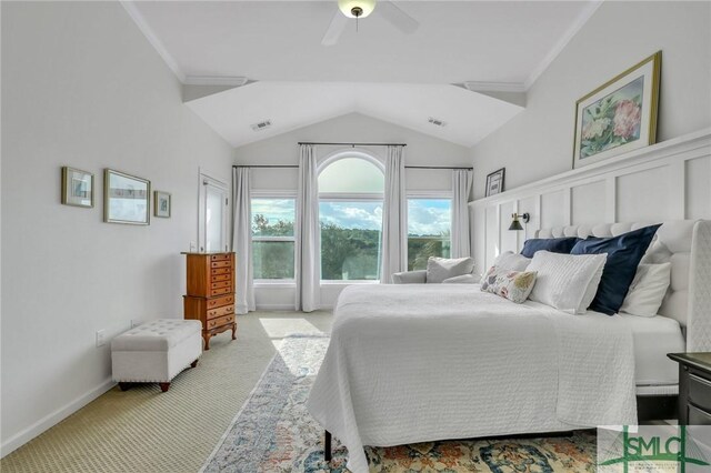 bedroom with ceiling fan, light carpet, lofted ceiling, and ornamental molding