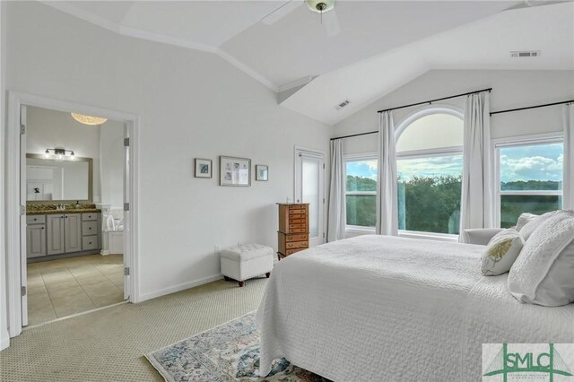 carpeted bedroom featuring ceiling fan, sink, ensuite bathroom, and lofted ceiling