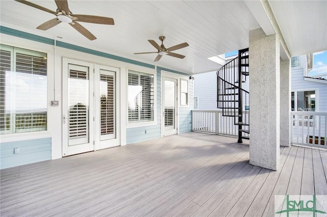 wooden terrace featuring french doors and ceiling fan