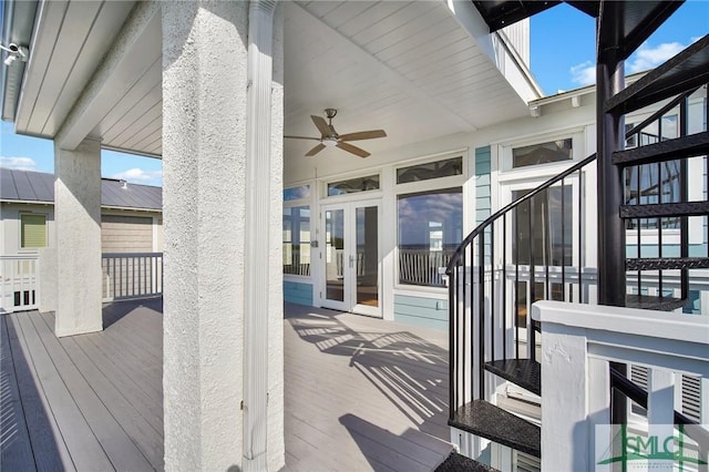 wooden deck featuring ceiling fan and french doors