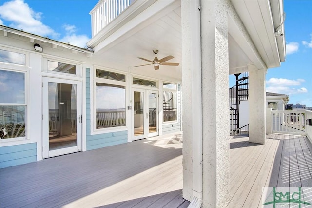 wooden deck with ceiling fan and french doors