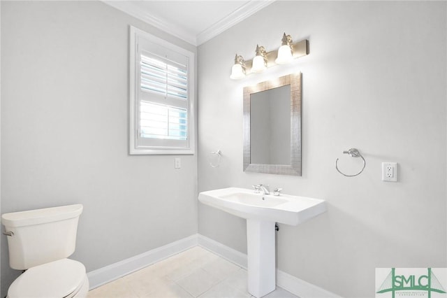 bathroom with tile patterned flooring, ornamental molding, and toilet