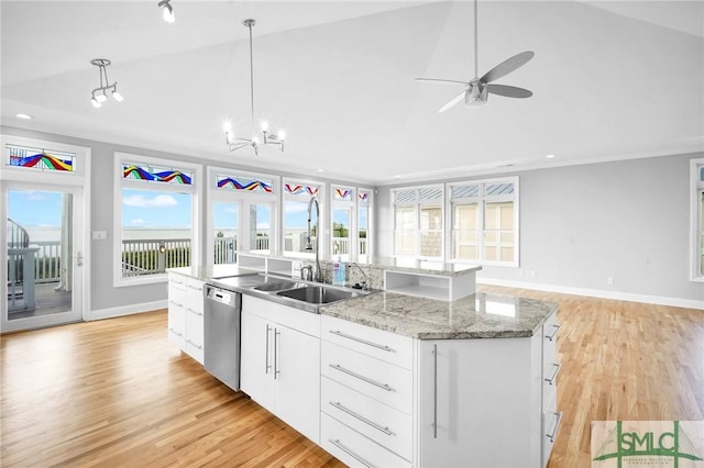 kitchen featuring white cabinetry, sink, hanging light fixtures, stainless steel dishwasher, and a center island with sink