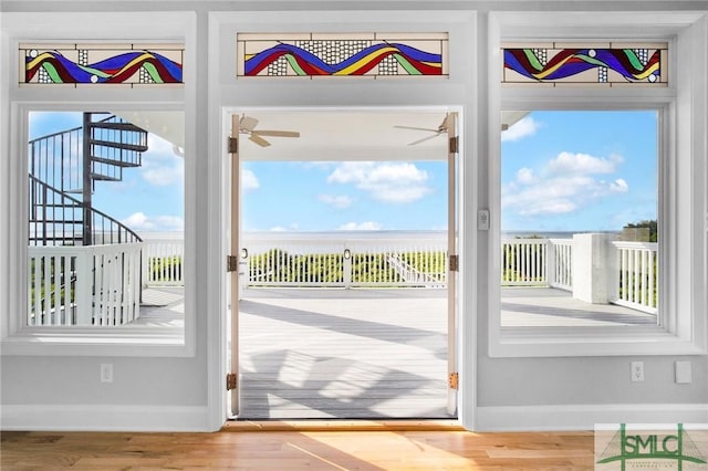 doorway featuring ceiling fan and wood-type flooring