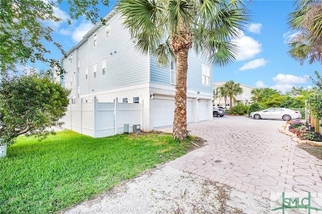 view of side of property featuring a yard and a garage