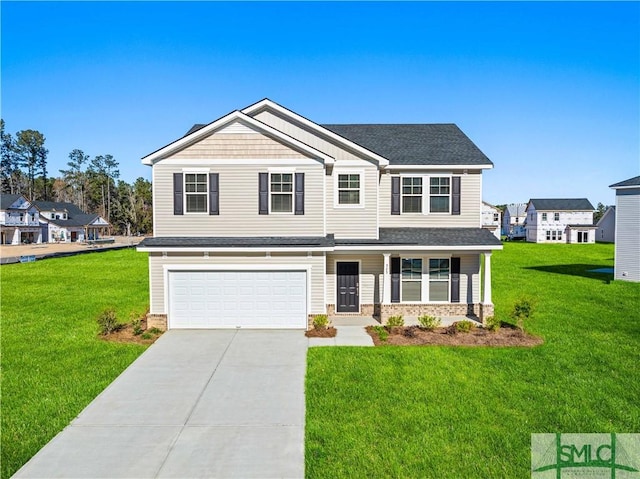 view of front of house featuring a garage and a front lawn