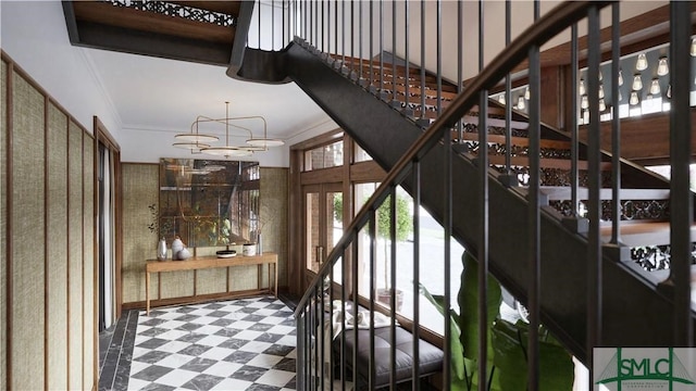 staircase featuring ornamental molding and an inviting chandelier