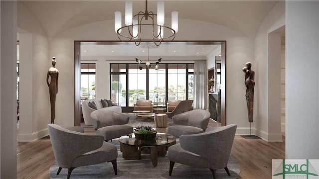 living room with lofted ceiling, a notable chandelier, and hardwood / wood-style floors